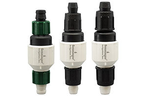 Studio image of three Senninger® PRLG Barb Pressure Regulators with barbed connections and reverse-thread locking nuts, designed for drip and field irrigation.