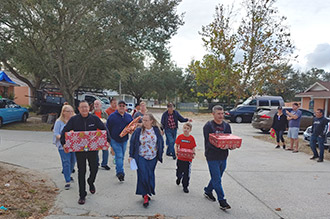 Clermont team Senninger Helping Others delivering gifts for families in need 